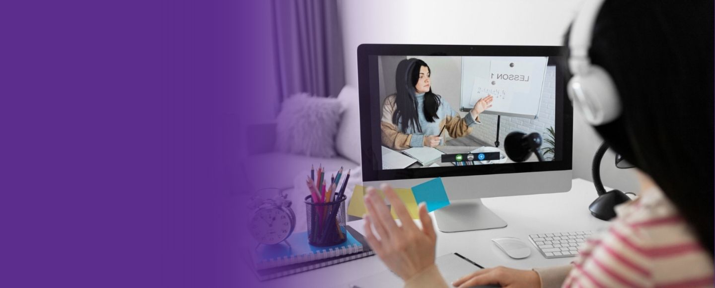 A student attending an online class on a desktop