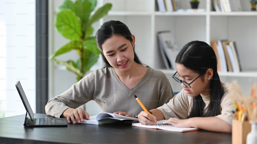 Tutor teaching online with laptop and tablet